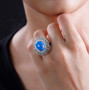 ceruleite and multi gemstone halo cocktail ring in rhodium over sterling silver worn on a hand
