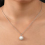 freshwater pearl and white zircon halo pendant necklace in rhodium over sterling silver worn around the neck