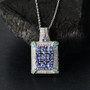 tanzanite paraiba tourmaline and diamond cluster pendant necklace in rhodium over sterling silver shown in a lifestyle photo