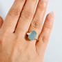 grandidierite and diamond 10k yellow gold ring worn on a hand