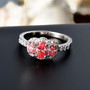 lab pink and white diamond oval halo trilogy ring in 950 platinum shown in a lifestyle photo
