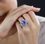 color change fluorite and white zircon ring in rhodium over sterling silver worn on a hand