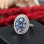 ceylon blue sapphire and white zircon cluster halo ring in rhodium over sterling silver shown in a lifestyle photo