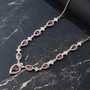 rhodolite garnet and white zircon necklace in 18k rose gold over sterling silver shown in a lifestyle photo