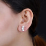 moissanite earrings in 18k yellow gold over sterling silver worn on the ear
