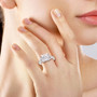 princess cut and round moissanite ring in 10k white gold worn on a hand
