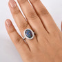 australian boulder opal and lab diamond oval halo ring in solid 10k white gold worn on a hand
