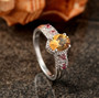 scapolite pink tourmaline and white zircon ring in rhodium over sterling silver shown in a lifestyle photo