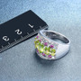 peridot rhodolite garnet and white zircon band ring in rhodium over sterling silver shown for size comparison