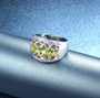 close up of peridot rhodolite garnet and white zircon band ring in rhodium over sterling silver