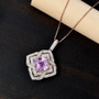 asscher cut kunzite and moissanite double halo pendant necklace in 18k rose gold over sterling silver shown in a lifestyle photo
