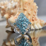 blue apatite cluster ring in 18k yellow gold and rhodium over sterling silver shown in a lifestyle photo