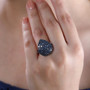 blue diamond cluster ring in rhodium over sterling silver worn on a hand