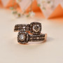 champagne diamond bypass ring in black rhodium and 18k rose gold over sterling silver shown in a lifestyle photo
