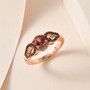 pink apatite brown and white zircon ring in 18k rose gold over sterling silver shown in a lifestyle photo