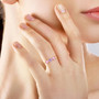 natural purple and pink sapphire and diamond ring in 14k yellow gold worn on a hand
