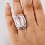 rose quartz cushion solitaire ring in rhodium over sterling silver worn on a hand