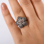 color change garnet and white zircon flower cluster ring in rhodium over sterling silver worn on a hand