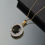 moldavite and moissanite oval double halo pendant necklace in 18k yellow gold over sterling silver shown in a lifestyle photo