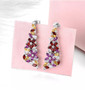 rhodolite garnet citrine and zircon dangle earrings in rhodium over sterling silver shown in a lifestyle photo
