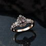color change garnet and moissanite pear halo ring in 18k rose gold over sterling silver shown in a lifestyle photo