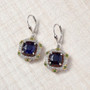 sapphire (ff) and multi gemstone regal halo earrings in 18k yellow gold and rhodium over sterling silver shown in a lifestyle photo