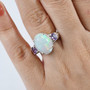 ethiopian opal and purple sapphire three stone ring in rhodium over sterling silver worn on a hand