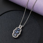 ceylon blue sapphire and zircon pendant necklace in rhodium over sterling silver shown in a lifestyle photo
