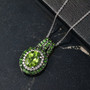 peridot chrome diopside and zircon pendant necklace in rhodium over sterling silver shown in a lifestyle photo