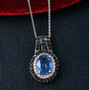 kyanite blue sapphire and zircon pendant necklace in rhodium over sterling silver shown in a lifestyle photo