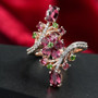 rhodolite garnet chrome diopside and white zircon bypass ring in 18k rose gold over sterling silver shown in a lifestyle photo