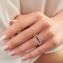red spinel and white zircon band ring in 14k yellow gold worn on a hand