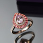 kunzite rubellite tourmaline and zircon double halo ring in 18k rose gold over sterling silver shown in a lifestyle photo