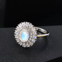 rainbow moonstone and zircon double halo ring in rhodium over sterling silver shown in a lifestyle photo
