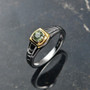 demantoid garnet solitaire gents ring in two-tone 18k yellow gold and rhodium over sterling silver shown in a lifestyle photo
