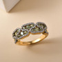 demantoid garnet and moissanite zigzag cluster band ring in 18k yellow gold over sterling silver shown in a lifestyle photo