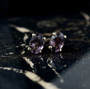 purple spinel oval stud earrings in 10k yellow gold shown in a lifestyle photo