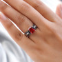 lab padparadscha sapphire and black spinel ring in black and white rhodium over sterling silver worn on a hand