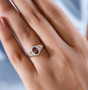 red and white zircon oval halo ring in two-tone 18k yellow gold and rhodium over sterling silver worn on a hand