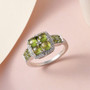 vesuvianite and white zircon cluster halo ring in rhodium over sterling silver shown in a lifestyle photo