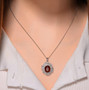 orange kyanite and moissanite bypass halo pendant necklace in rhodium over sterling silver worn around the neck
