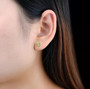 peridot 6mm heart stud earrings in rhodium over sterling silver worn on the ear