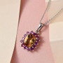 scapolite and rhodolite garnet cushion halo pendant necklace in rhodium over sterling silver shown in a lifestyle photo
