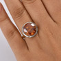 sphalerite and diamond round halo ring in 10k yellow gold worn on a hand