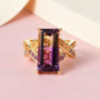 ametrine amethyst and citrine criss cross band ring in 18k yellow gold over sterling silver shown in a lifestyle photo