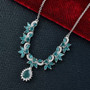 grandidierite and moissanite lariat necklace in rhodium over sterling silver shown in a lifestyle photo