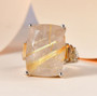 rutilated quartz and citrine cocktail ring in rhodium over sterling silver shown in a lifestyle photo