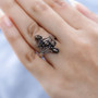 black star sapphire five stone ring in rhodium over sterling silver worn on a hand