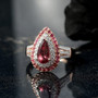 pink apatite pink tourmaline and moissanite pear double halo ring in 18k rose gold over sterling silver shown in a lifestyle photo