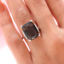 columbianite and diamond cushion solitaire ring in 18k white gold worn on a hand
